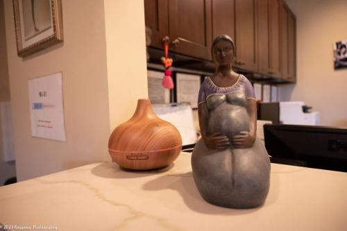 Pregnant figurine on front desk