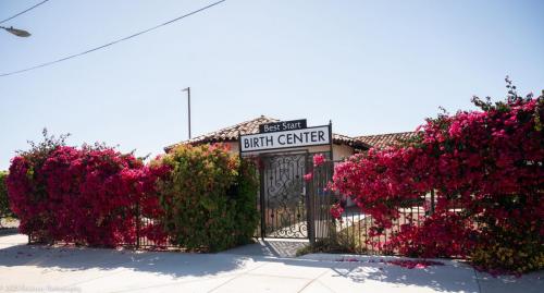 Font of Best Start Birth Center, wide view, gate with flowers.